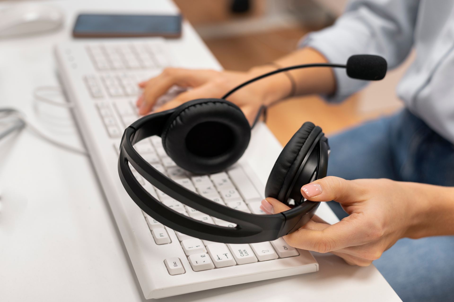 woman-working-call-center-holding-pair-headphones (1) woman-working-call-center-holding-pair-headphones (1)