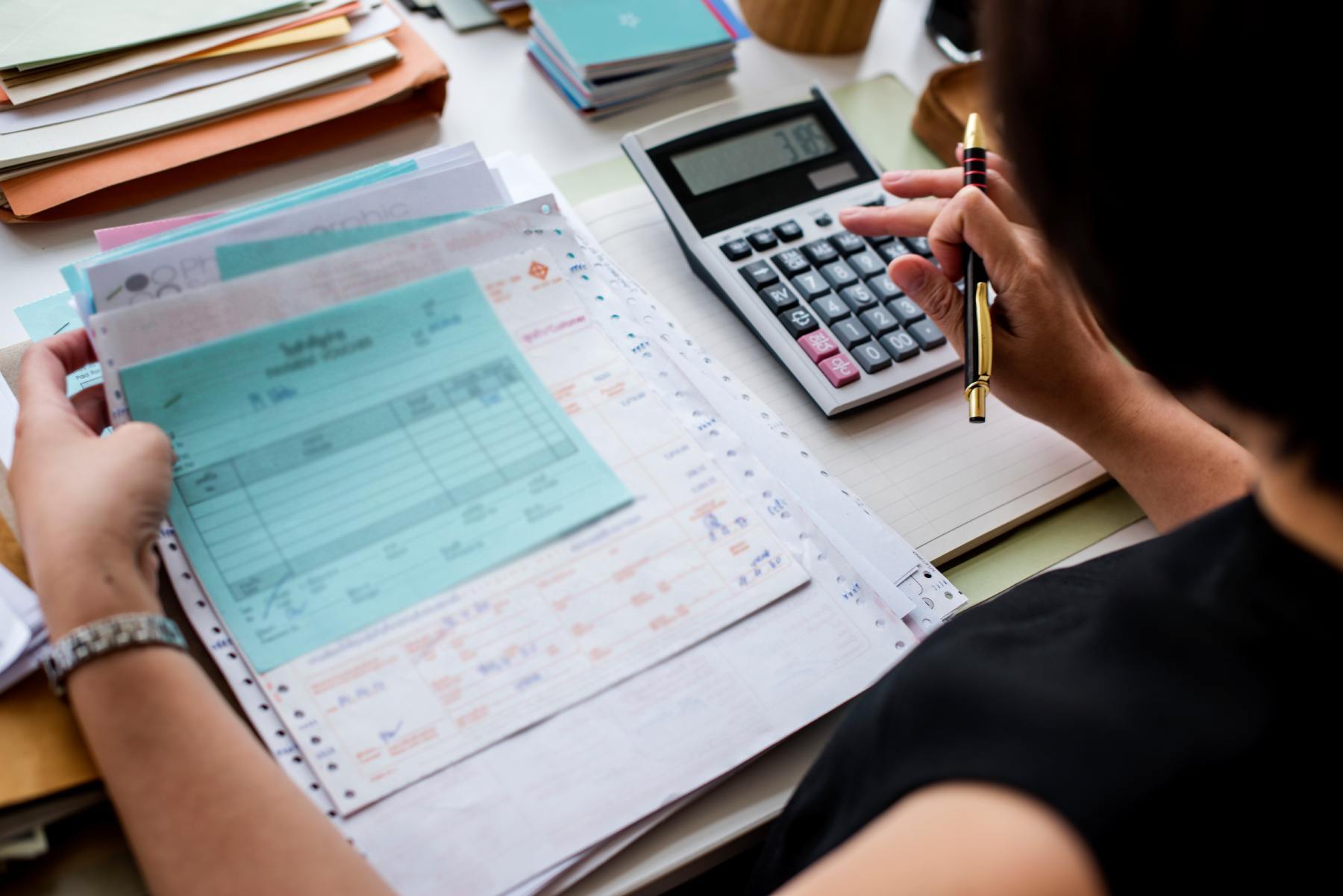 asian-woman-working-through-paperwork-1 asian-woman-working-through-paperwork-1