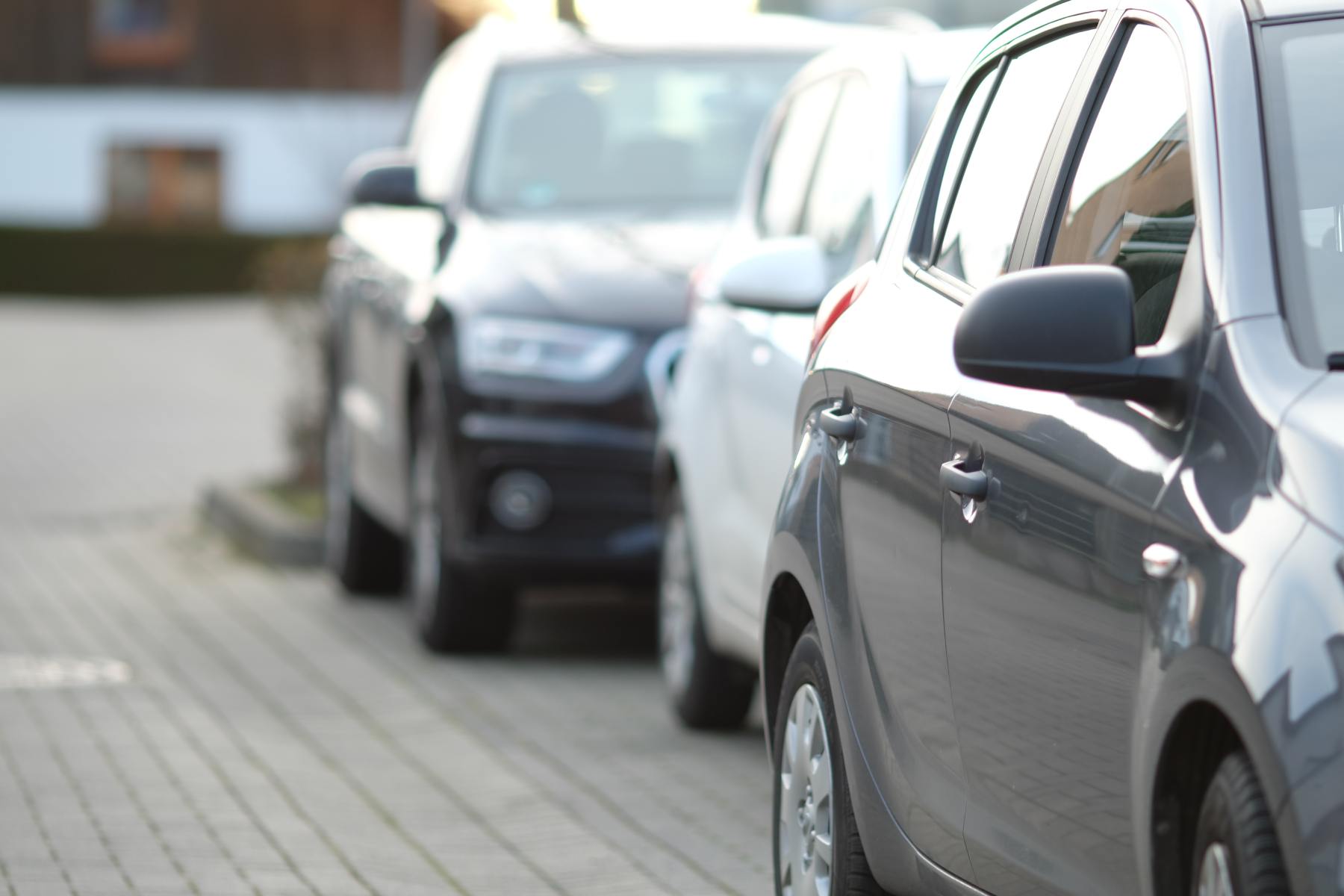 closeup-shot-black-car-parking-lot-with-blurred-background (1) closeup-shot-black-car-parking-lot-with-blurred-background (1)